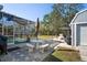 Backyard patio featuring stone pavers, a seating area, outdoor grill, and view of the pool at 13045 Marbled Godwit Rd, Weeki Wachee, FL 34614