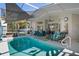 View of the sparkling pool with patio furniture, and clear view of the outdoor lanai at 13045 Marbled Godwit Rd, Weeki Wachee, FL 34614