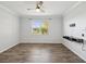 Serene bedroom features a ceiling fan, a window and luxury vinyl plank flooring at 13619 Bee Tree Ct, Hudson, FL 34669