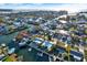 Aerial view of waterfront homes with boat docks and access to the open water at 13906 Barnard Ave, Hudson, FL 34667