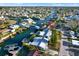 Aerial view of waterfront homes with boat docks, canals, and lush landscaping at 13906 Barnard Ave, Hudson, FL 34667