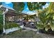Lush outdoor entertainment space with a tiki bar and seating area, perfect for tropical gatherings at 13906 Barnard Ave, Hudson, FL 34667