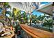 Outdoor bar area featuring custom surfboard bar top and tropical decor at 13906 Barnard Ave, Hudson, FL 34667