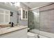 Neutral toned bathroom featuring a vanity with granite countertops and an enclosed tub shower at 13906 Barnard Ave, Hudson, FL 34667