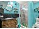 Vibrant bathroom with a custom vanity, whimsical décor, and a shower featuring decorative glass doors at 13906 Barnard Ave, Hudson, FL 34667
