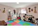 Versatile bonus room perfect for exercise or hobbies, featuring colorful flooring and ample natural light at 13906 Barnard Ave, Hudson, FL 34667