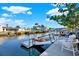 Waterfront dock with boat lift, seating, and serene water views at 13906 Barnard Ave, Hudson, FL 34667