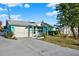 View of the home with a driveway and lush landscaping, offering curb appeal and character at 13906 Barnard Ave, Hudson, FL 34667