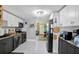 Well-lit kitchen with stainless steel appliances, modern cabinetry, and tiled floors at 13906 Barnard Ave, Hudson, FL 34667