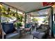 Relaxing screened-in lanai perfect for entertaining, featuring comfortable seating and string lights at 13906 Barnard Ave, Hudson, FL 34667