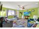 Living room with colorful decor, tile floors, and plenty of space for relaxation at 13906 Barnard Ave, Hudson, FL 34667