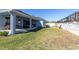 Well-maintained backyard with covered patio, perfect for outdoor entertaining and relaxation at 1436 Gopher Loop, Tarpon Springs, FL 34689