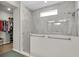 Modern bathroom featuring a marble-tiled shower with glass door and access to a walk-in closet at 1436 Gopher Loop, Tarpon Springs, FL 34689