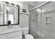 Sleek bathroom featuring a glass-enclosed shower, modern vanity, and neutral color palette at 1436 Gopher Loop, Tarpon Springs, FL 34689
