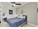 Cozy bedroom featuring a comfortable bed, ceiling fan, and stylish decor creating a relaxing space at 1436 Gopher Loop, Tarpon Springs, FL 34689