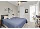Inviting bedroom with a ceiling fan, ample natural light, and tasteful furnishings at 1436 Gopher Loop, Tarpon Springs, FL 34689