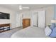 Bedroom with neutral walls, wood-look flooring, and TV at 1436 Gopher Loop, Tarpon Springs, FL 34689