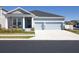 Charming single-story home featuring a two-car garage and manicured landscaping, creating an inviting curb appeal at 1436 Gopher Loop, Tarpon Springs, FL 34689