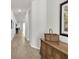 Bright and airy hallway showcasing beautiful flooring and seamlessly connecting various living spaces at 1436 Gopher Loop, Tarpon Springs, FL 34689