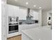 Modern kitchen features stainless appliances and an island sink at 1436 Gopher Loop, Tarpon Springs, FL 34689