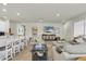 Bright, airy living room with seamless flow to the kitchen, showcasing modern open-concept design at 1436 Gopher Loop, Tarpon Springs, FL 34689