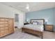 Main bedroom featuring light blue accent wall and wood furniture at 1436 Gopher Loop, Tarpon Springs, FL 34689