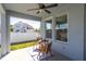 Cozy outdoor patio with table and chairs, overlooking a well-maintained backyard at 1436 Gopher Loop, Tarpon Springs, FL 34689