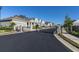 Street view of gated community with modern homes and well-manicured landscaping at 1436 Gopher Loop, Tarpon Springs, FL 34689