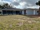 Expansive screened-in patio offering a seamless indoor-outdoor living experience in a well-maintained backyard at 1713 Walden Ct, Englewood, FL 34224