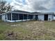 Large screened in patio and view of the freshly painted exterior of this single Gathering home at 1713 Walden Ct, Englewood, FL 34224