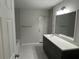 Contemporary bathroom with a dark vanity and a large mirror at 1713 Walden Ct, Englewood, FL 34224