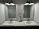 A modern bathroom vanity with double sinks and lighting fixtures at 1713 Walden Ct, Englewood, FL 34224