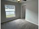 Inviting bedroom featuring plush carpeting and a window overlooking a screened-in patio at 1713 Walden Ct, Englewood, FL 34224