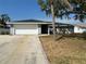 Exterior of a single-story home featuring a well-kept lawn, driveway, and attached two-car garage at 1713 Walden Ct, Englewood, FL 34224