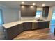 Spacious kitchen with quartz countertops, stainless steel appliances, modern cabinets, and wood flooring, perfect for cooking at 1713 Walden Ct, Englewood, FL 34224