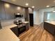 The kitchen showcases stainless steel appliances, sleek countertops, and modern gray cabinets for a stylish cooking space at 1713 Walden Ct, Englewood, FL 34224