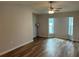 The living room has a ceiling fan and lots of natural light at 1713 Walden Ct, Englewood, FL 34224
