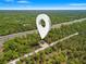 Expansive aerial view of a wooded homesite ready for building, with convenient road access at 18082 Parakeet Rd, Brooksville, FL 34614
