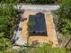 The home sits on a wooded lot with a perimeter line for hardscaping as seen from this high aerial view at 18082 Parakeet Rd, Brooksville, FL 34614
