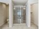 Bathroom features a modern glass shower, a toilet, and a door leading to closet shelving at 2433 Fairview Rd, Spring Hill, FL 34609