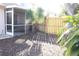 A view of the backyard with mulch, green plants, and a screened-in porch at 2568 W Brook Ln, Clearwater, FL 33761