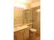 Bathroom with a sliding glass shower door, toilet, vanity with a mirror and decorative lighting at 2568 W Brook Ln, Clearwater, FL 33761