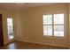 Bedroom with a door, window with shutters, wood floors, and neutral wall color at 2568 W Brook Ln, Clearwater, FL 33761