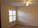 A well-lit bedroom featuring a ceiling fan, window with shutters, and laminate flooring at 2568 W Brook Ln, Clearwater, FL 33761