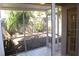 View of the outdoor patio area featuring a screen enclosure, tile flooring, and fenced backyard at 2568 W Brook Ln, Clearwater, FL 33761
