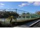Outdoor tennis court with perimeter fence at 2568 W Brook Ln, Clearwater, FL 33761