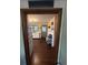 View of the kitchen from the hall showing white cabinetry and a vintage aesthetic at 38533 8Th Ave, Zephyrhills, FL 33542