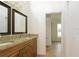 Bathroom with double sinks, granite countertops and wooden cabinets at 39127 Pretty Pond Rd, Zephyrhills, FL 33540