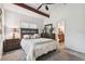 Bedroom featuring beamed ceilings, an ensuite bathroom and cozy carpet floors at 39127 Pretty Pond Rd, Zephyrhills, FL 33540