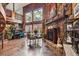 Cozy living room with a stone fireplace, wood paneling, and a staircase leading to the upper level at 39127 Pretty Pond Rd, Zephyrhills, FL 33540